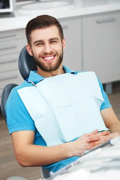 man smiling in the dental chair at Comprehensive Dentistry