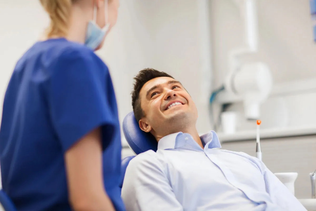 man laying back in the dental chair at Comprehensive Dentistry in Ypsilanti, MI