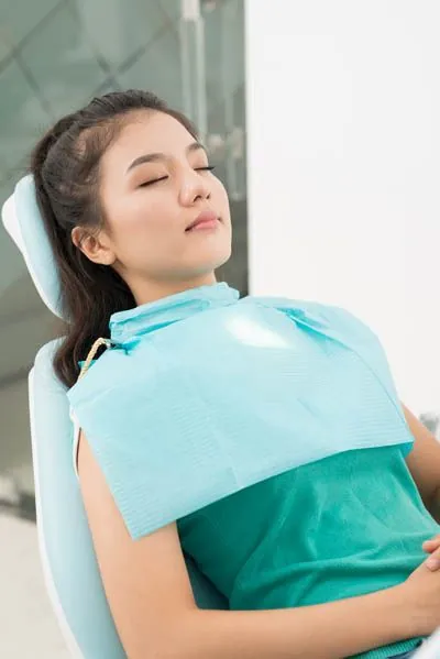 woman laying back having a comfortable experience at Comprehensive Dentistry in Ypsilanti, MI