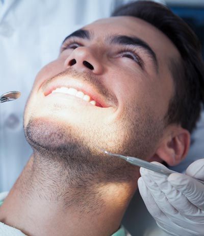 man receiving a dental checkup at Comprehensive Dentistry in Ypsilanti, MI