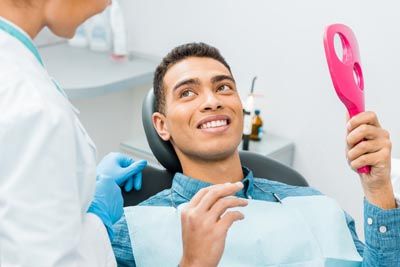 man satisfied with the results of his cosmetic dentistry procedure at Comprehensive Dentistry