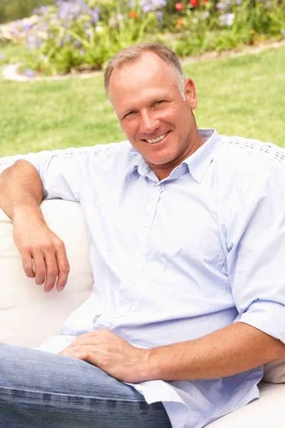 man smiling with his new dental implants