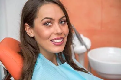 woman smiling big during her dental appointment