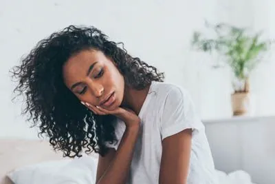 woman experiencing TMJ pain