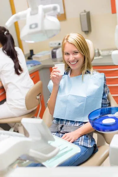 woman smiling in the dental chair after a successful dental procedure