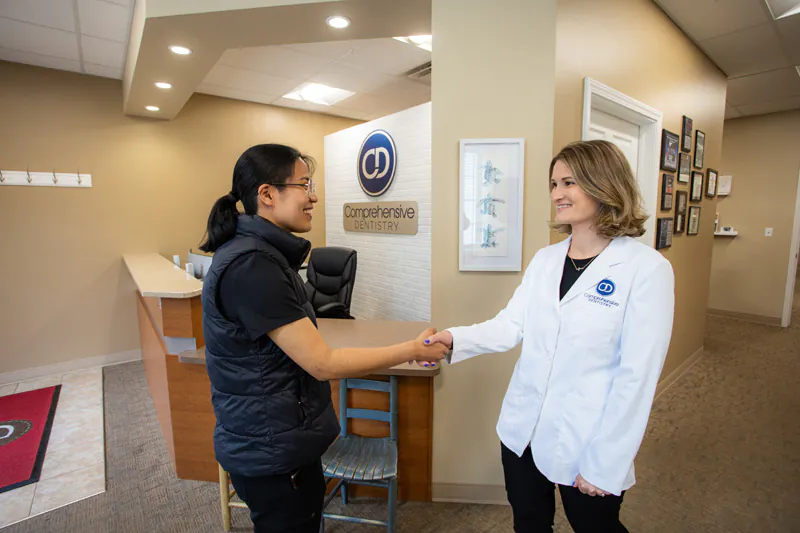 Dr. A shaking a patients hand at Comprehensive Dentistry in Ypsilanti, MI